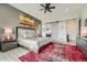Spacious main bedroom featuring a dark accent wall and a modern barn door to ensuite at 10689 Shadow Pines Rd, Parker, CO 80138