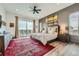 Luxurious main bedroom with a large bed, balcony access, and mountain views at 10689 Shadow Pines Rd, Parker, CO 80138