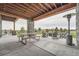 Inviting outdoor patio with stone columns, picnic table, patio heater, and fire pit seating for backyard relaxation at 10689 Shadow Pines Rd, Parker, CO 80138