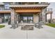 Outdoor patio featuring a stone fire pit and Adirondack chairs, perfect for entertaining guests and enjoying the open air at 10689 Shadow Pines Rd, Parker, CO 80138