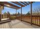 Back deck featuring wood railings and a shaded pergola that overlooks the backyard at 1300 Iris Cir, Broomfield, CO 80020