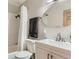Bright bathroom featuring a vanity with storage, an oval mirror, and a shower with subway tile surround at 3061 W 18Th Ave, Denver, CO 80204