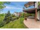 Spacious backyard features a patio, a deck, and lush landscaping with flowers and mature trees at 12888 Buckhorn Creek St, Parker, CO 80134