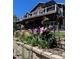 Captivating backyard featuring a multi-level deck, beautiful flowers, and a charming garden area at 12888 Buckhorn Creek St, Parker, CO 80134
