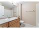 Bright bathroom featuring a single sink vanity, large mirror, and white tiled floors and shower at 12888 Buckhorn Creek St, Parker, CO 80134