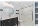Updated bathroom features a modern vanity, an oval mirror, and a glass-enclosed shower at 12888 Buckhorn Creek St, Parker, CO 80134