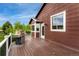 Corner of a wood deck on a bright day with a grill and view of trees and a blue sky at 12888 Buckhorn Creek St, Parker, CO 80134
