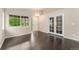 Entryway featuring dark wood floors, natural light, and access to a room through French doors at 12888 Buckhorn Creek St, Parker, CO 80134