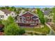 Charming exterior showcasing a large deck, a well-maintained lawn, and established trees and garden at 12888 Buckhorn Creek St, Parker, CO 80134