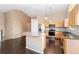 Eat-in kitchen with stainless steel appliances, center island and hardwood floors at 12888 Buckhorn Creek St, Parker, CO 80134
