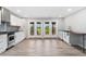 Well-lit kitchen with white cabinets, stainless steel appliances, hardwood floors and view of outside at 12888 Buckhorn Creek St, Parker, CO 80134