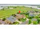 Aerial view of a home nestled near open spaces with a playground and lake views in the distance at 26631 E Arbor Dr, Aurora, CO 80016