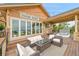 Outdoor living space featuring a hot tub, cozy seating, and a folding glass door at 26631 E Arbor Dr, Aurora, CO 80016