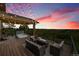 Relaxing back deck with a hot tub, seating area, and fire table, perfect for enjoying the scenic views at 26631 E Arbor Dr, Aurora, CO 80016