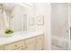 Bright bathroom vanity area featuring soft colors and modern fixtures, leading to the toilet and shower area at 26631 E Arbor Dr, Aurora, CO 80016