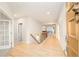 Spacious entryway with light wood floors, a staircase, and views into the living areas at 26631 E Arbor Dr, Aurora, CO 80016