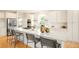 Bright kitchen with a large island, white cabinets, stainless steel appliances and modern bar stools at 26631 E Arbor Dr, Aurora, CO 80016