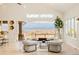 Open-concept living room with floor-to-ceiling windows providing scenic views and an adjoining terrace at 26631 E Arbor Dr, Aurora, CO 80016