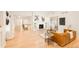 Bright and open living space featuring a fireplace, modern furnishings, and hardwood floors at 26631 E Arbor Dr, Aurora, CO 80016