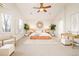 Bright and spacious main bedroom features neutral colors, a ceiling fan, and large windows at 26631 E Arbor Dr, Aurora, CO 80016