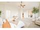 A spacious main bedroom with double doors leading to living space, soft colors, and ceiling fan at 26631 E Arbor Dr, Aurora, CO 80016