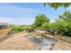 Outdoor patio and seating area with lake views and manicured landscaping at 26631 E Arbor Dr, Aurora, CO 80016