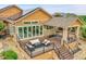 A raised deck with a fire pit, outdoor seating, and a covered area with a hot tub adds appeal at 26631 E Arbor Dr, Aurora, CO 80016