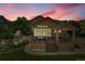 Beautiful home featuring an outdoor deck with a hot tub, fire pit and lush landscaped backyard at 26631 E Arbor Dr, Aurora, CO 80016