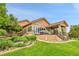 Charming home with a landscaped backyard and a cozy outdoor living space on the raised deck at 26631 E Arbor Dr, Aurora, CO 80016