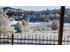 Snowy backyard vista offers an idyllic winter scene with trees and mountains visible from the balcony at 7482 Sleeping Bear Trl, Littleton, CO 80125