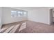 Bright bedroom with carpeted floors and multiple windows at 4620 Thistle Dr, Brighton, CO 80601