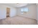 Bedroom with carpeted floor, a window, and access to a bathroom at 4620 Thistle Dr, Brighton, CO 80601