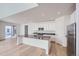 Modern kitchen with white cabinets, a large island, and stainless steel appliances at 4620 Thistle Dr, Brighton, CO 80601