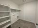 Bright laundry room with built-in shelving at 4620 Thistle Dr, Brighton, CO 80601