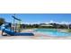 Community pool with water slide and playground at 4620 Thistle Dr, Brighton, CO 80601