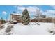 Snowy backyard with mature tree and detached garage at 5035 W 32Nd Ave, Denver, CO 80212