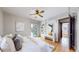 Bright bedroom with hardwood floors, built-in shelving, and french doors at 5035 W 32Nd Ave, Denver, CO 80212