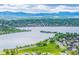 Expansive aerial view of Sloan's Lake surrounded by lush greenery, a serene neighborhood, and distant mountains at 1800 Grove St, Denver, CO 80204