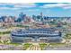 Spectacular aerial view featuring Empower Field stadium set against a vibrant city skyline and expansive blue sky at 1800 Grove St, Denver, CO 80204