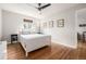Bright bedroom with hardwood floors, a ceiling fan and a window with blinds at 1800 Grove St, Denver, CO 80204