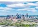 Panoramic cityscape view showcasing a vibrant mix of modern skyscrapers and lively amusement park attractions at 1800 Grove St, Denver, CO 80204