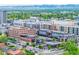 Vibrant cityscape featuring modern apartments, bustling streets, and Odell Brewing Co, with scenic mountain views at 1800 Grove St, Denver, CO 80204