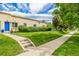 Side view of a charming home with a well-maintained lawn and mature trees at 1800 Grove St, Denver, CO 80204