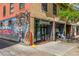Charming brick building exterior featuring colorful tiger mural and commercial space with an apartment for rent sign at 1800 Grove St, Denver, CO 80204