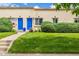 Charming townhome featuring a well-maintained lawn, blue front door, and manicured landscaping at 1800 Grove St, Denver, CO 80204