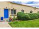 Cozy townhome boasting a vibrant blue door, terracotta roof, and lush, manicured landscaping at 1800 Grove St, Denver, CO 80204