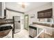 Well-lit kitchen with stainless steel appliances, stylish counters and door to backyard at 1800 Grove St, Denver, CO 80204