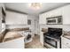 Bright kitchen featuring stainless steel appliances, granite counters and white cabinets at 1800 Grove St, Denver, CO 80204