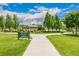 Scenic park with walking paths, lush green grass, mature trees, and the Melrose Inspirational Garden sign at 1800 Grove St, Denver, CO 80204