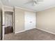Bedroom with tan walls, ceiling fan, carpeting, and a view to the hallway at 3968 Ashcroft Ave, Castle Rock, CO 80104